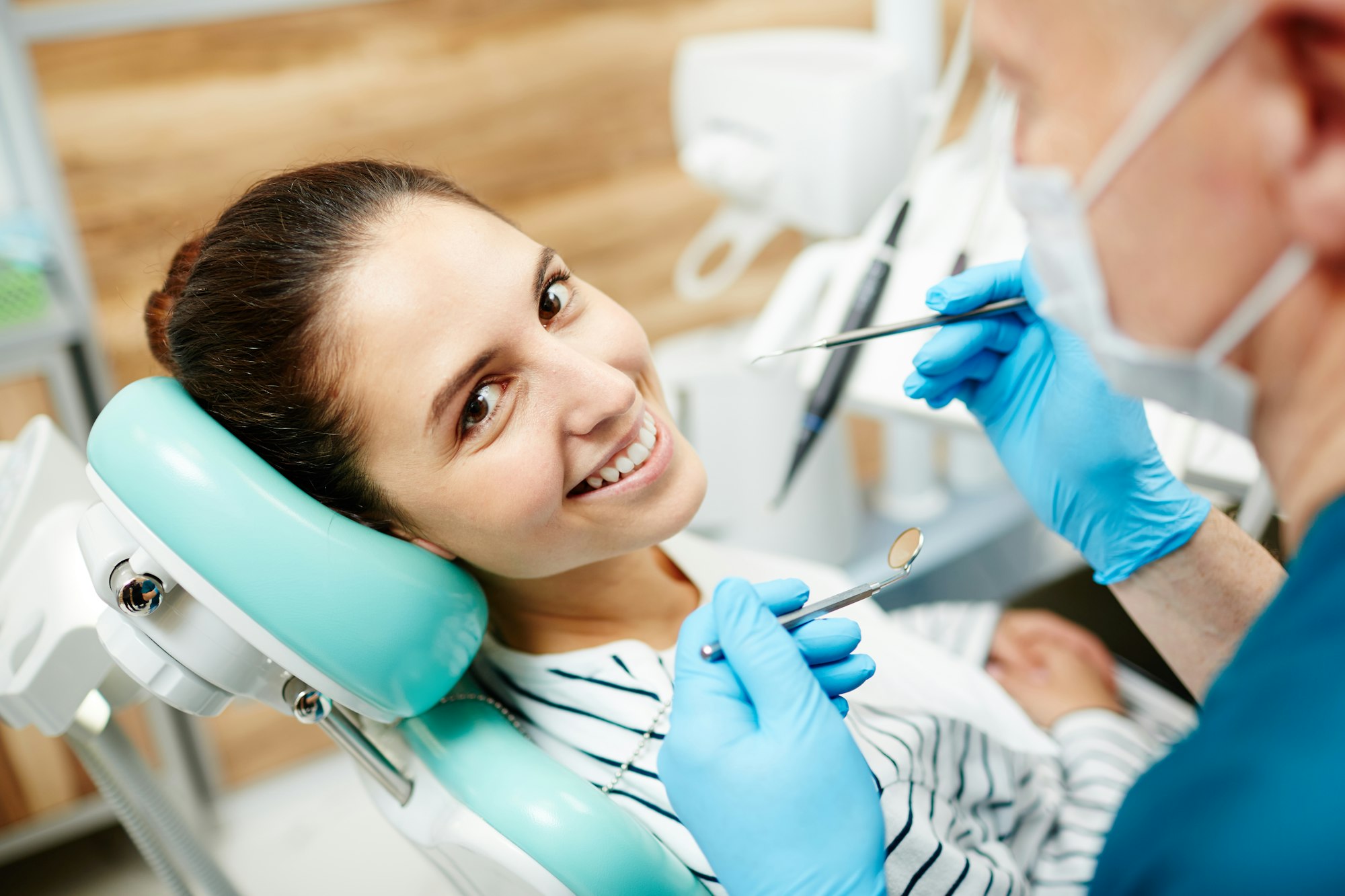 Young woman smiling during dental exam at Bright Choice Dentistry, showcasing the importance of regular dental checkups for maintaining a healthy smile.